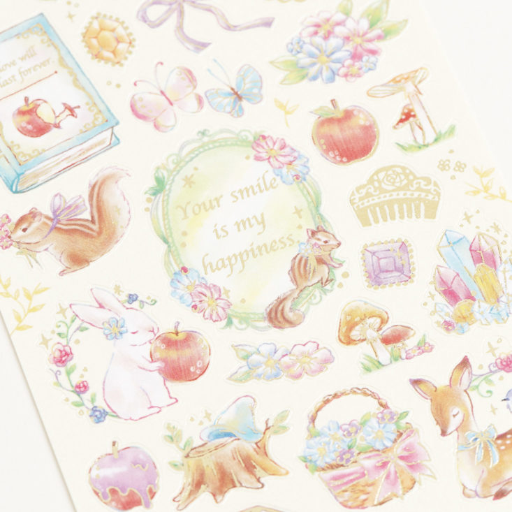 close up of gold foil forest animal and fruit stickers