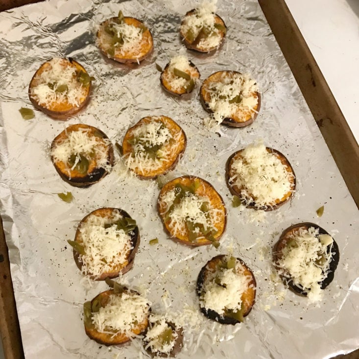 cooked sliced sweet potatoes topped with cheese and jalapeno