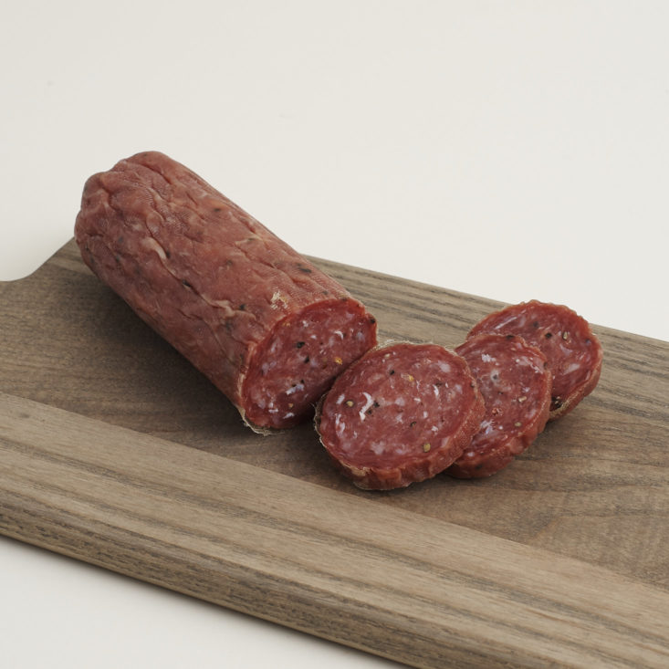 Salami Rustico from Parma Sausage sliced on a cutting board
