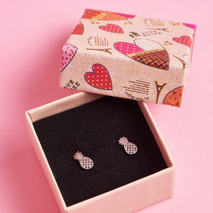 open earrings box with pineapple earrings inside