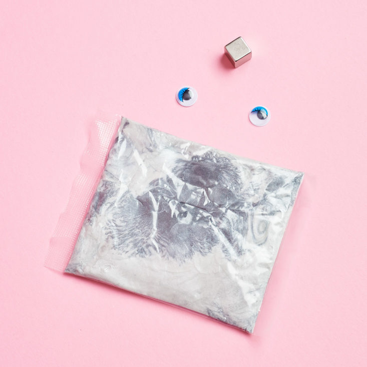 tiny silver pouch with puddy inside