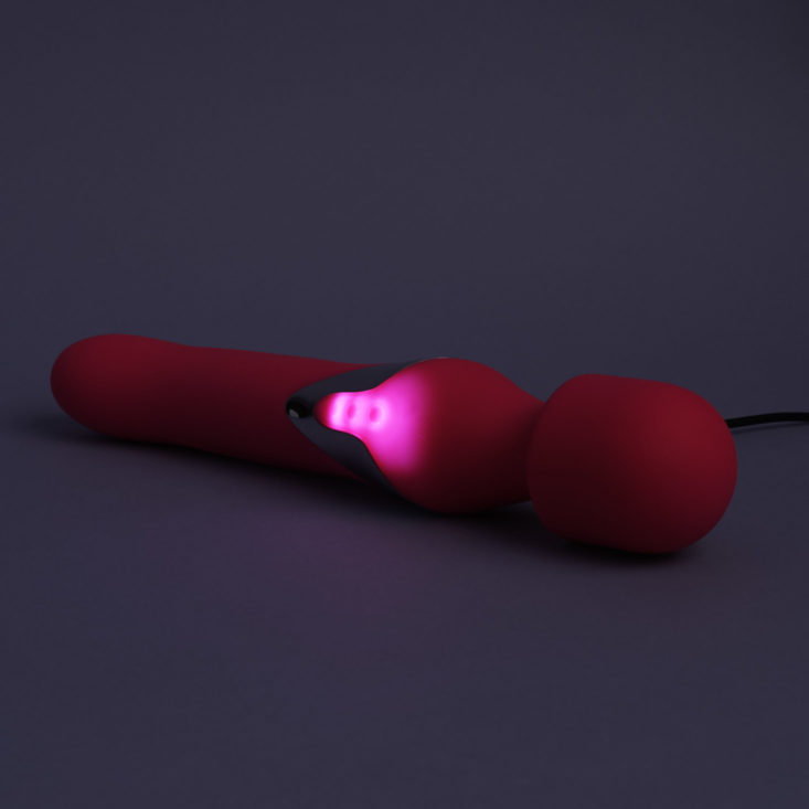 pink Aphojoy Angel personal massager glowing while charging