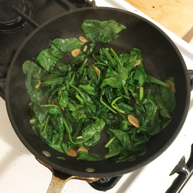 spinach and garlic cooking in pan