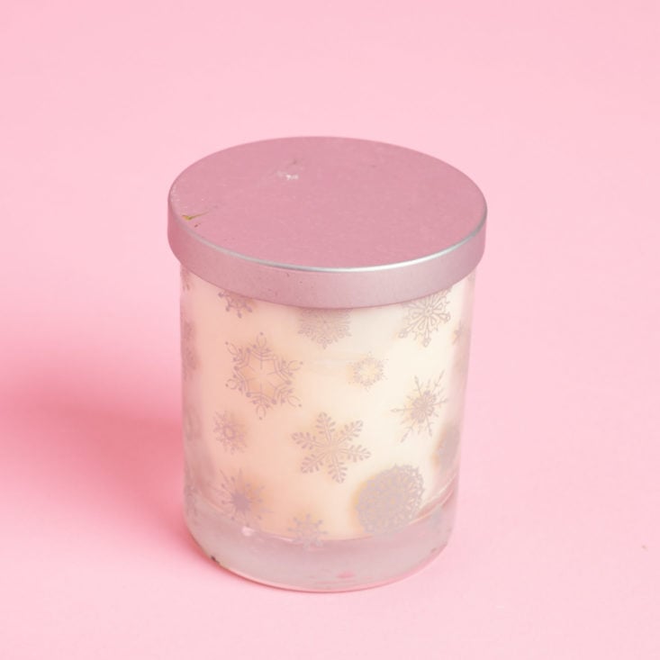 minty candle with snowflake patterned votive