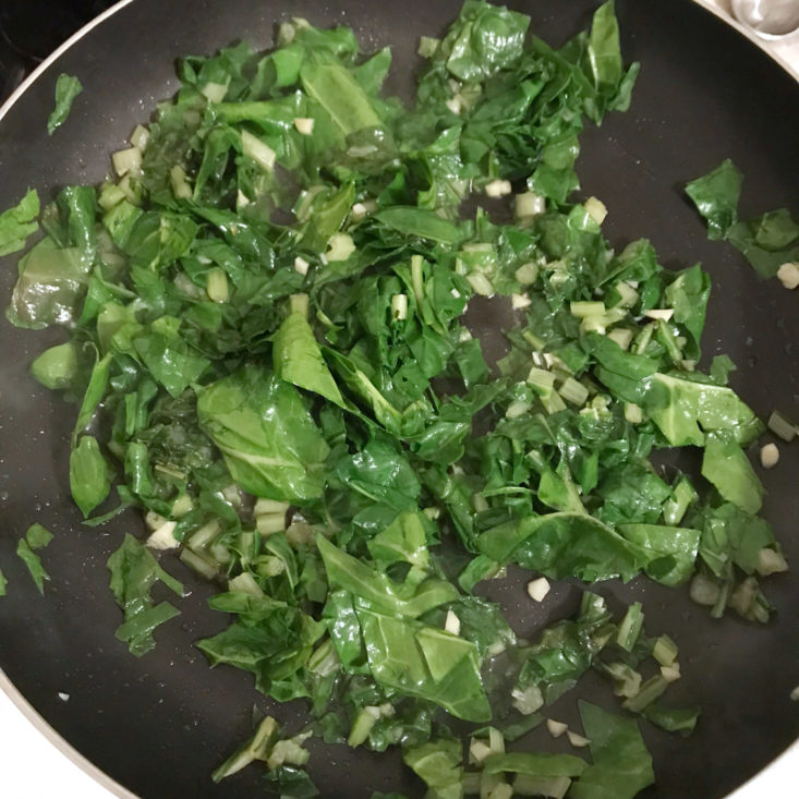 chard and garlic cooking in pan