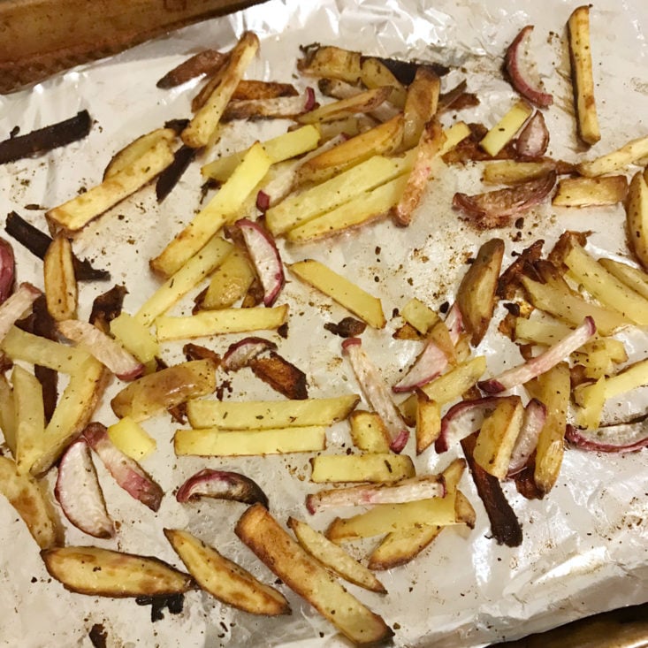 cooked sliced potatoes and turnips on baking sheet