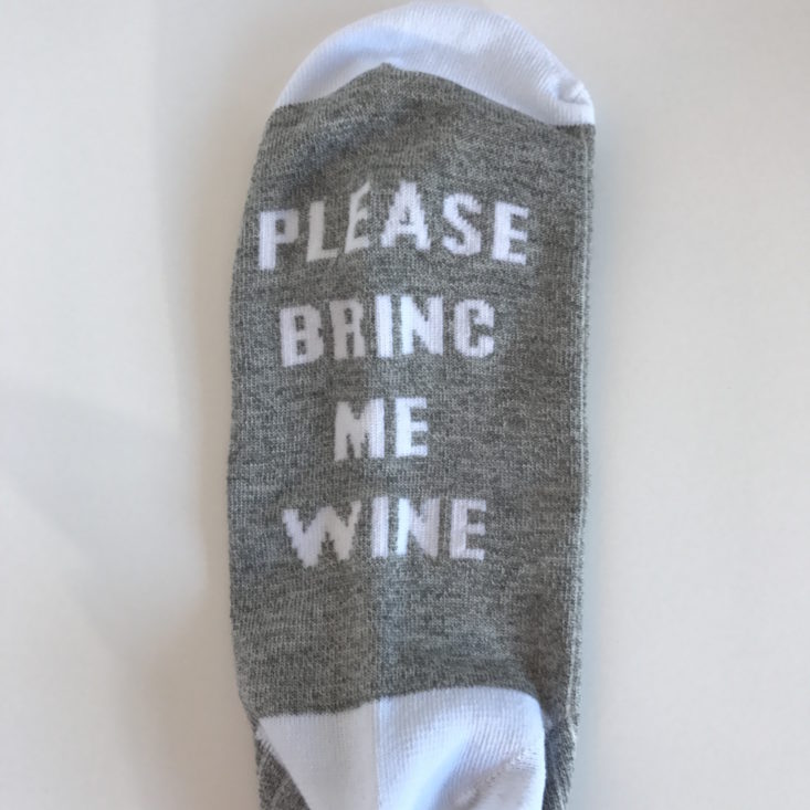 Bottom of sock with "Please Bring me Wine" saying