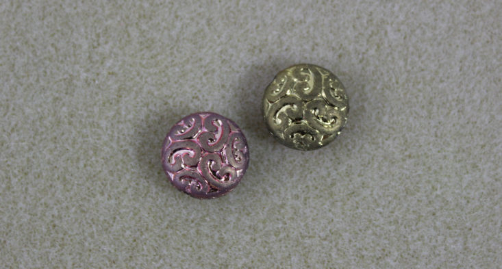 a pink and a gold bead with unique texture