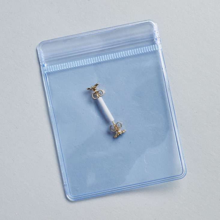 tiny butterfly earrings in clear plastic zip-shut package