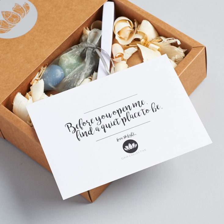 inside the december 2017 gaia collective moon box, which includes an envelope and curls of wood as packaging