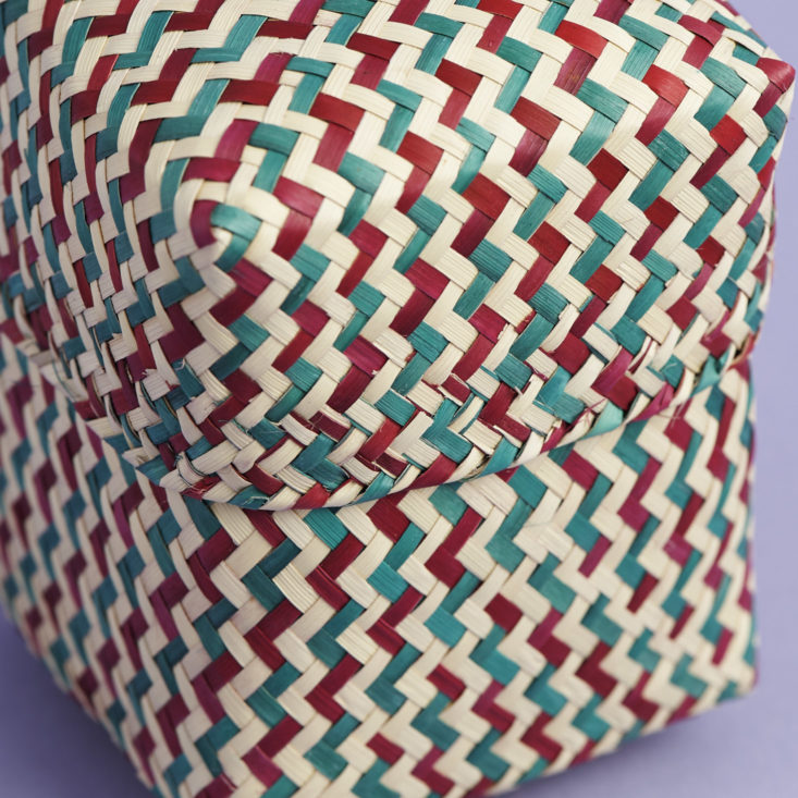 close up of mini maroon, green and natural palm leaf basket