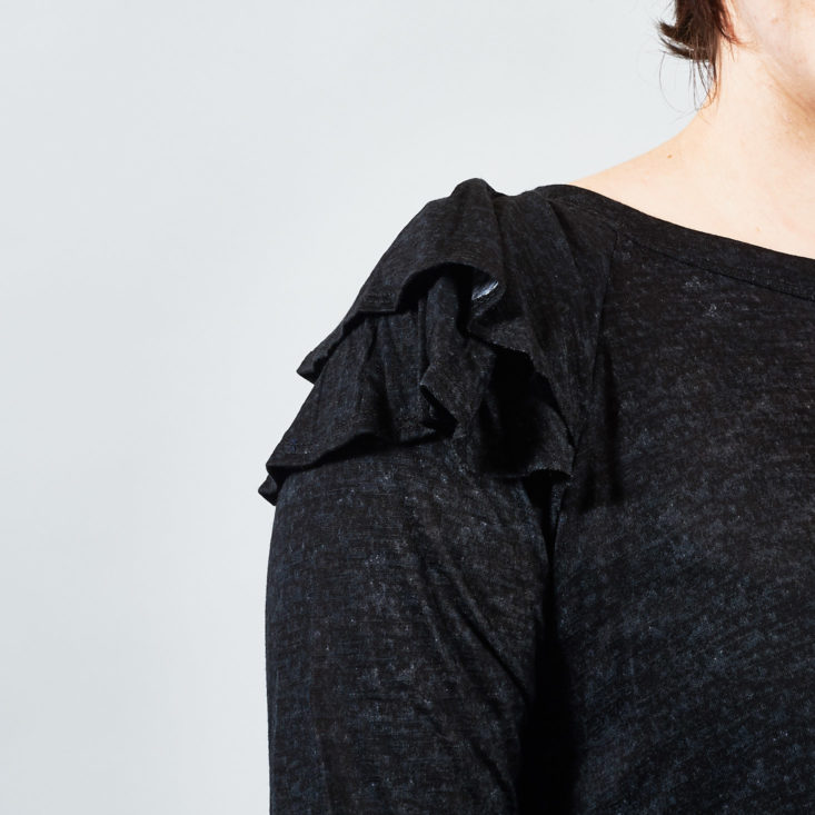 Ruffle detail on the sleeve of this black top