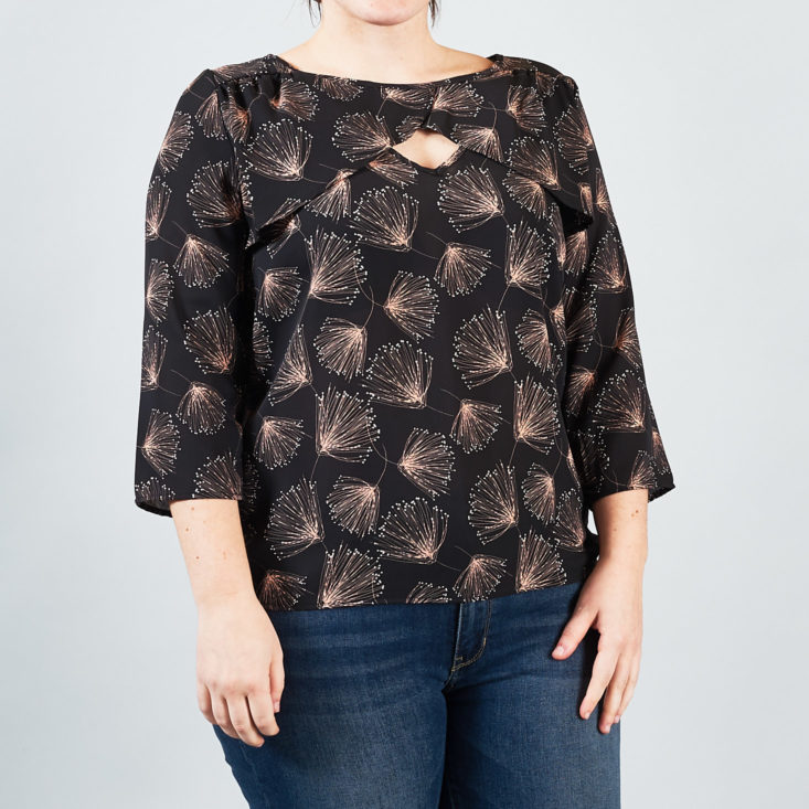 The pink patterns on this black 3/4 sleeve blouse look like dandelion seeds