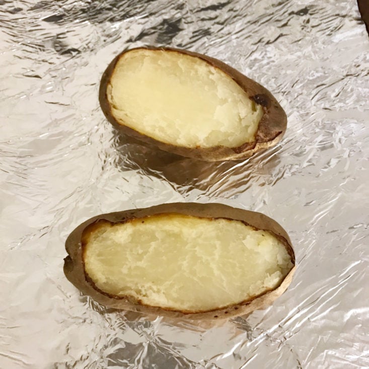 baked potatoes with tops cut off on baking sheet