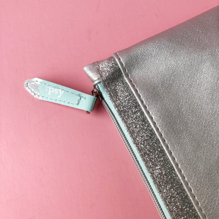 closeup of zipper on metallic silver cosmetic bag from Ipsy