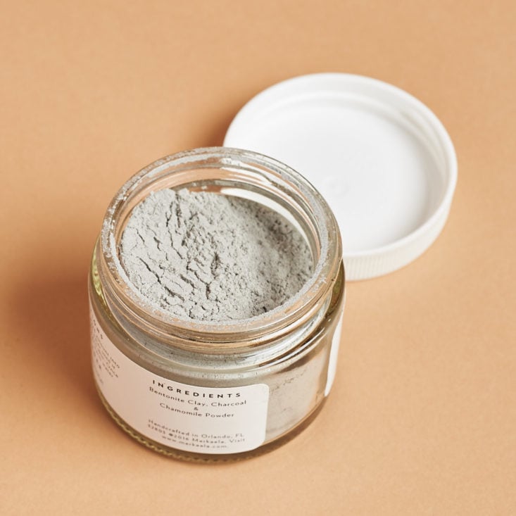 bentonite clay mask in an open, small glass jar