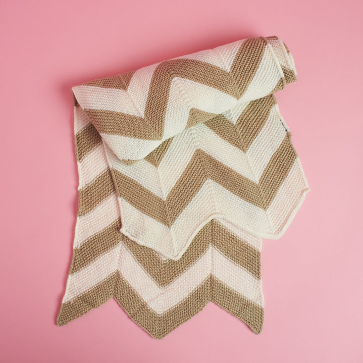 folded beige and white chevron scarf