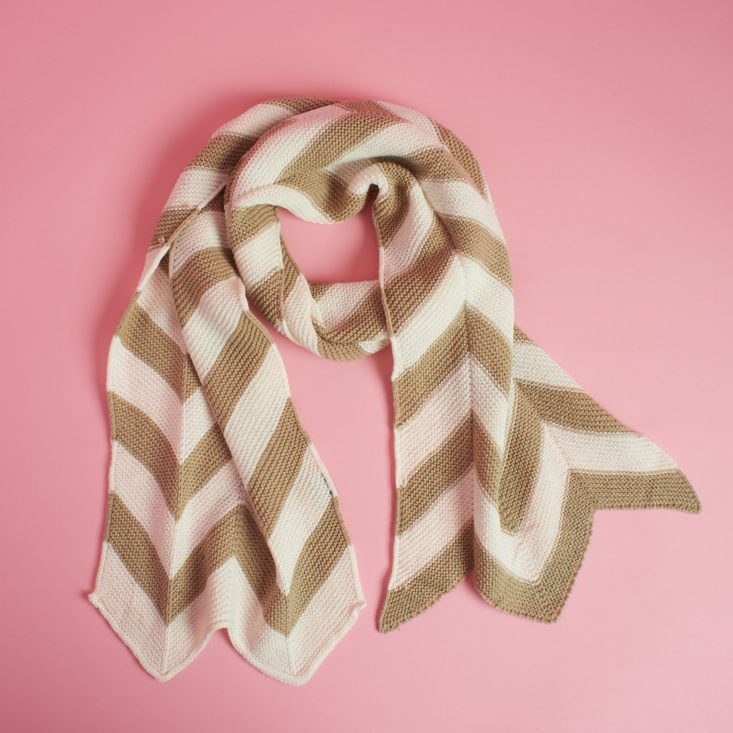beige chevron patterned scarf laying down in a loop