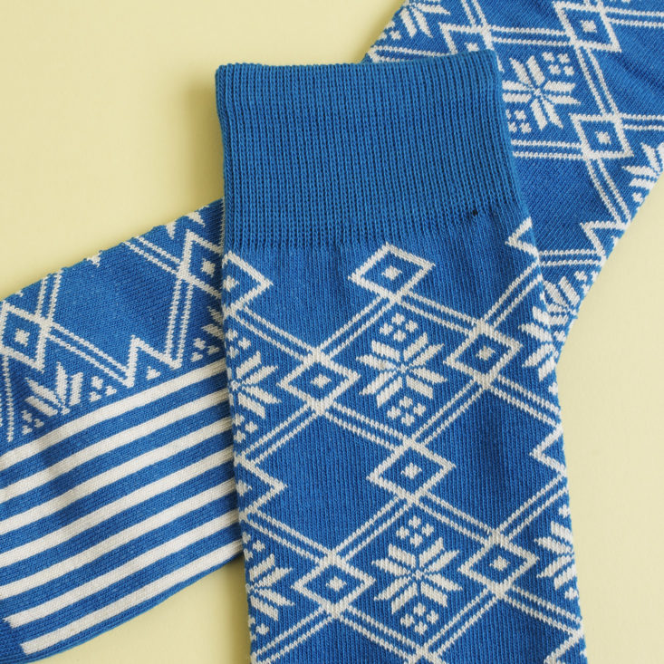 close up of Blue and white snowflake patterned socks
