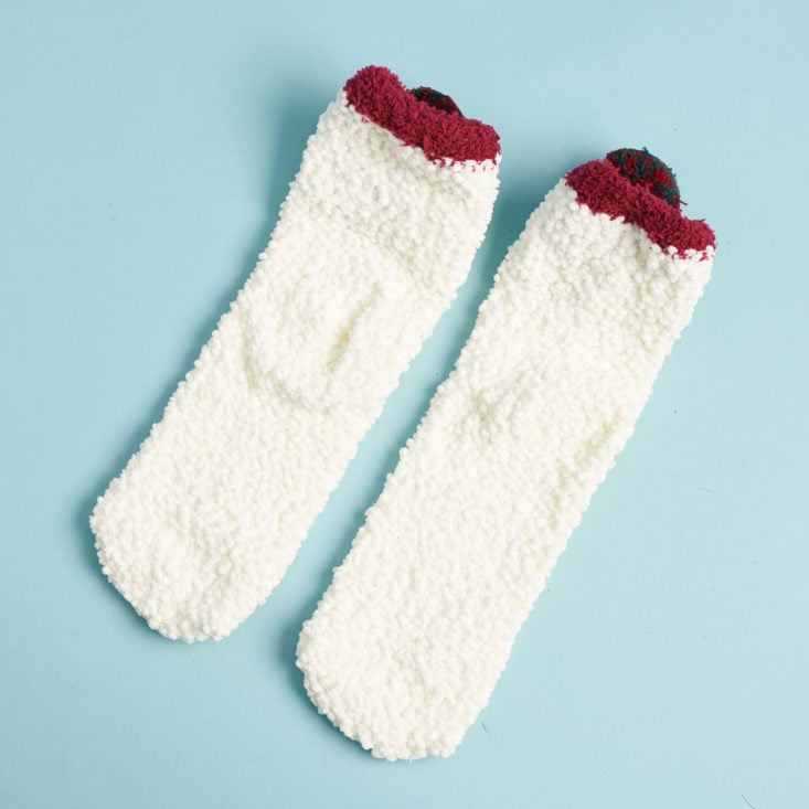 backs and bottoms of a pair of white nubbly snowman socks