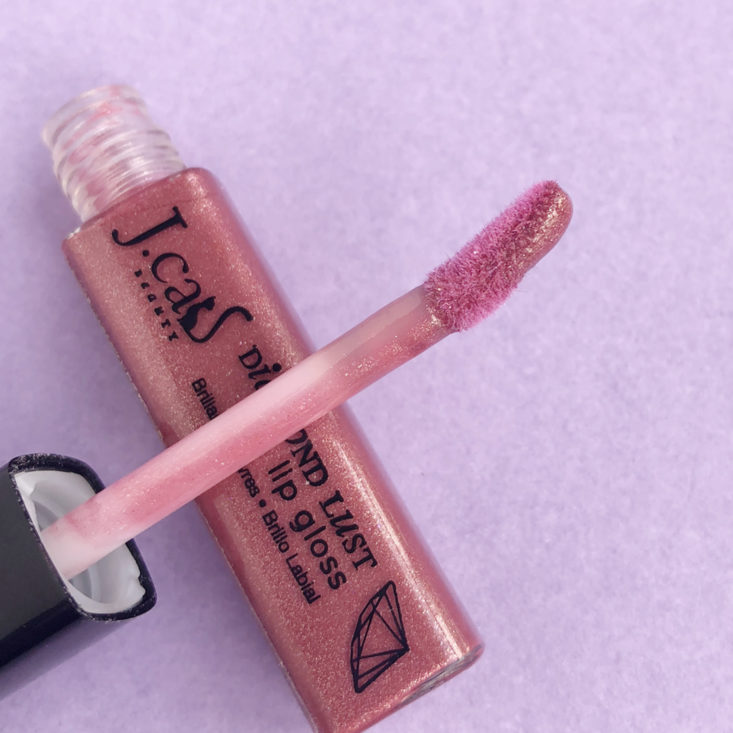 applicator of a rosy lipgloss
