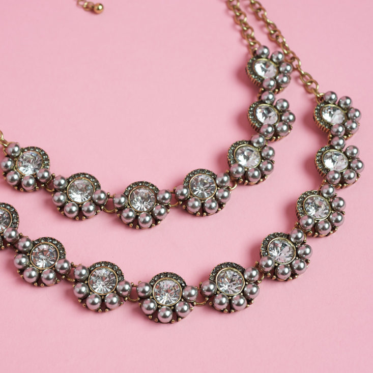 close up of the statement gems and rhinestone discs on a double-stranded necklace