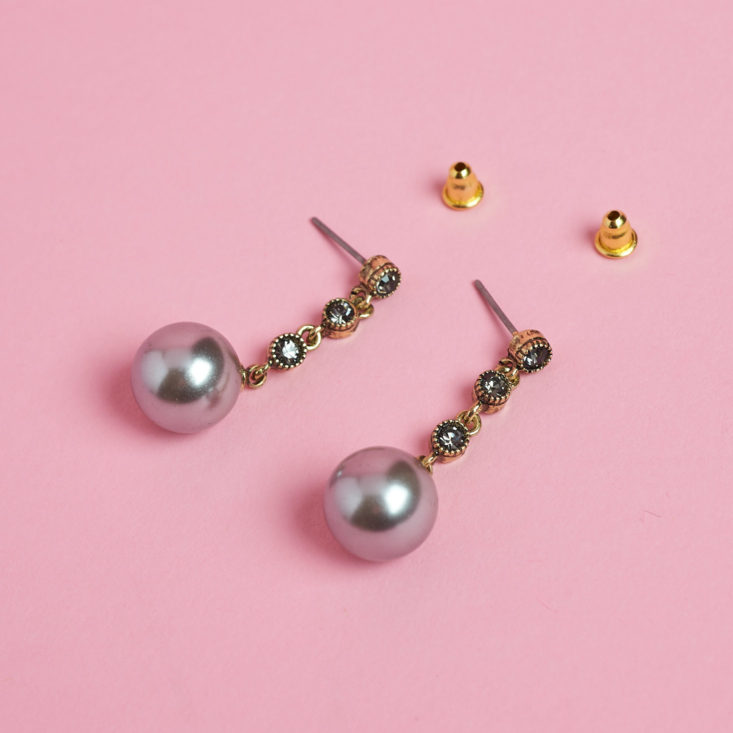 peal drop earrings laying on table with backings off