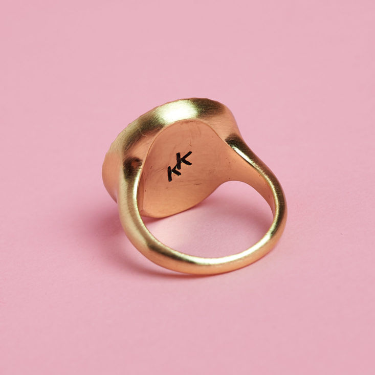 gold ring with circle gem detail from behind