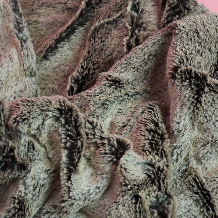 up close on brown furry material that makes up circle scarf