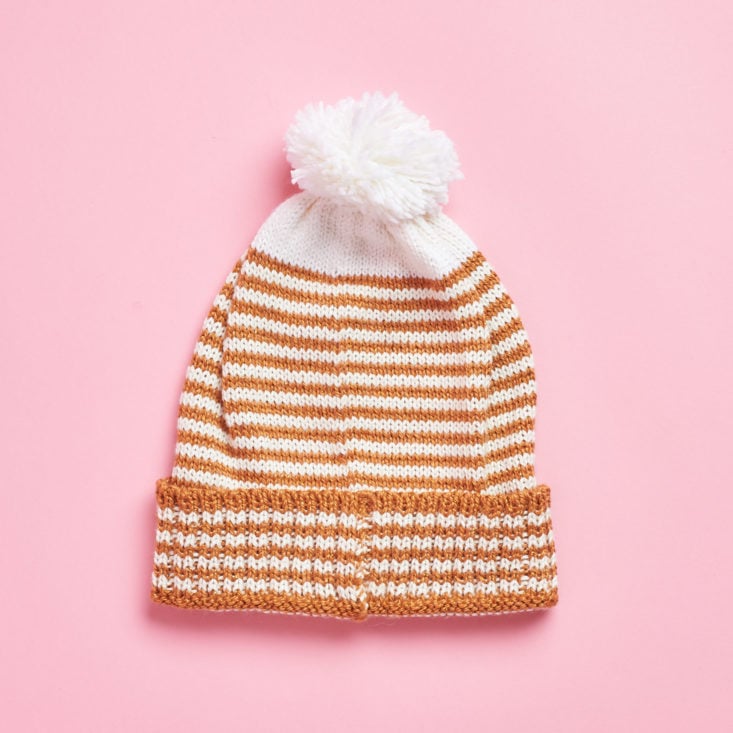 tan and white beanie with pom pom