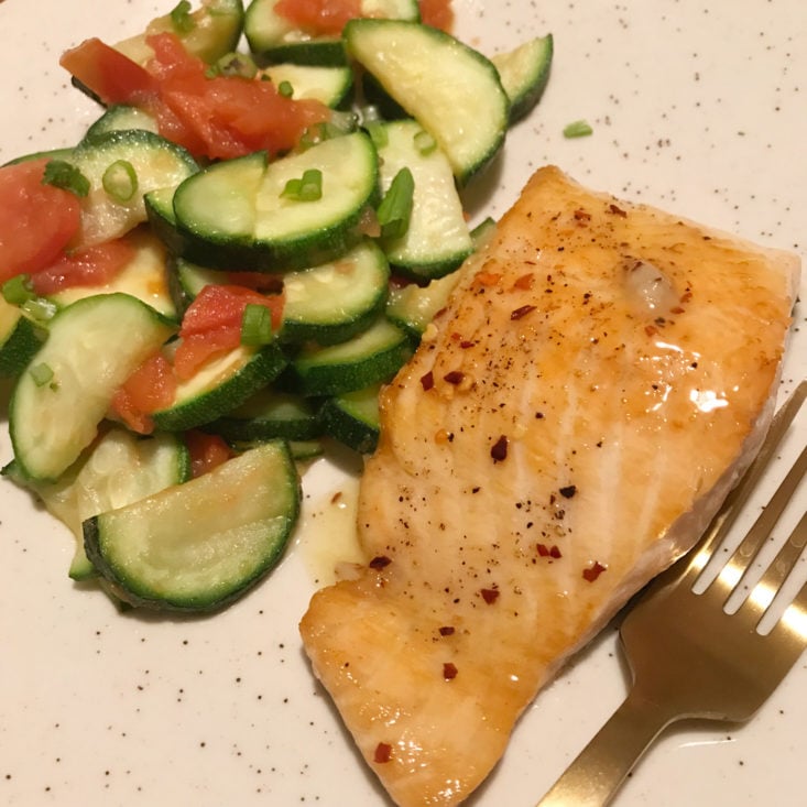 close up of finished hot honey salmon with zucchini and tomatoes