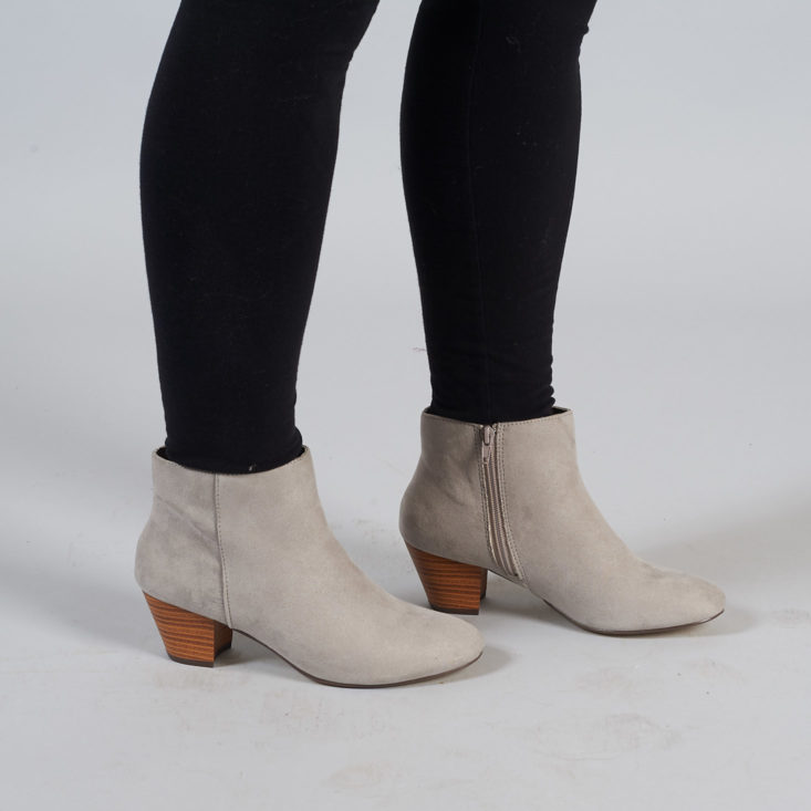 gray booties on person