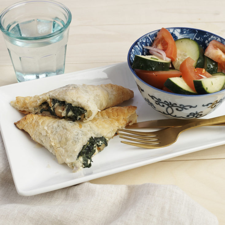 spinach and feta pocket and bowl of cucumber tomato salad