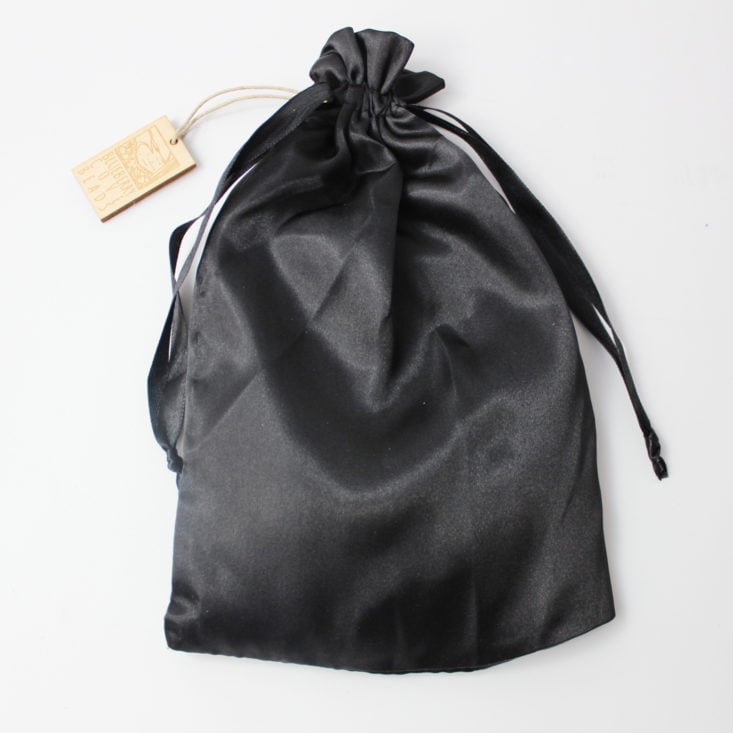 black satin pouch cinched closed