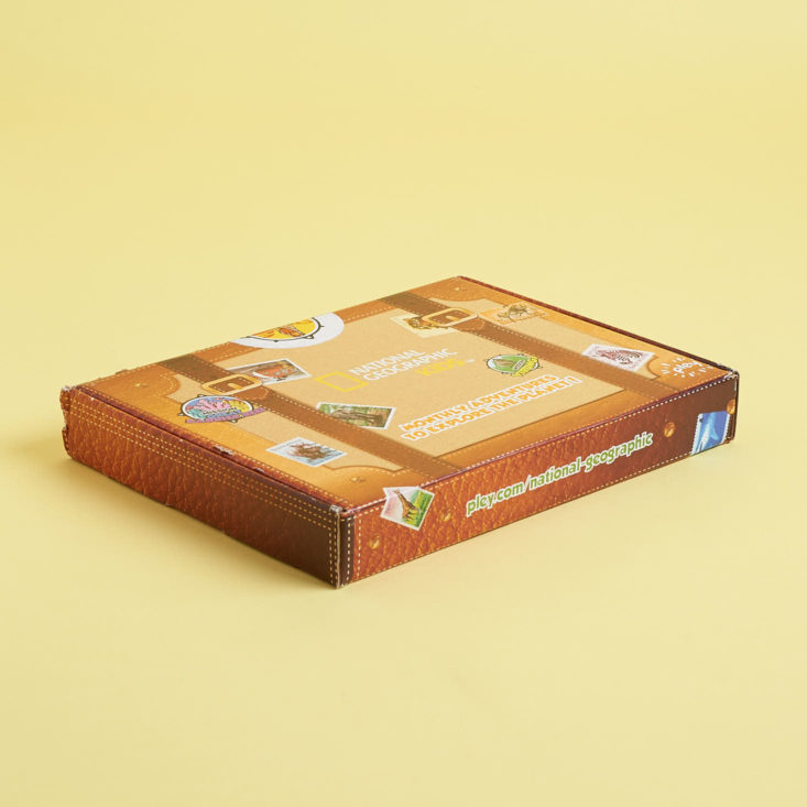 Each box is shaped like a suitcase and decorated with adventure and travel stickers