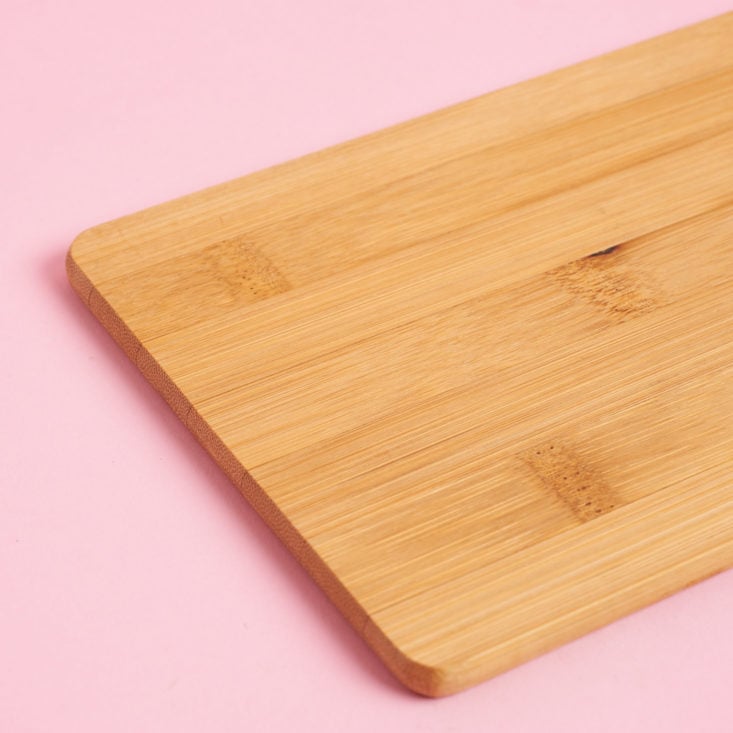 mini mystery box of awesome for april closeup on wooden cutting board