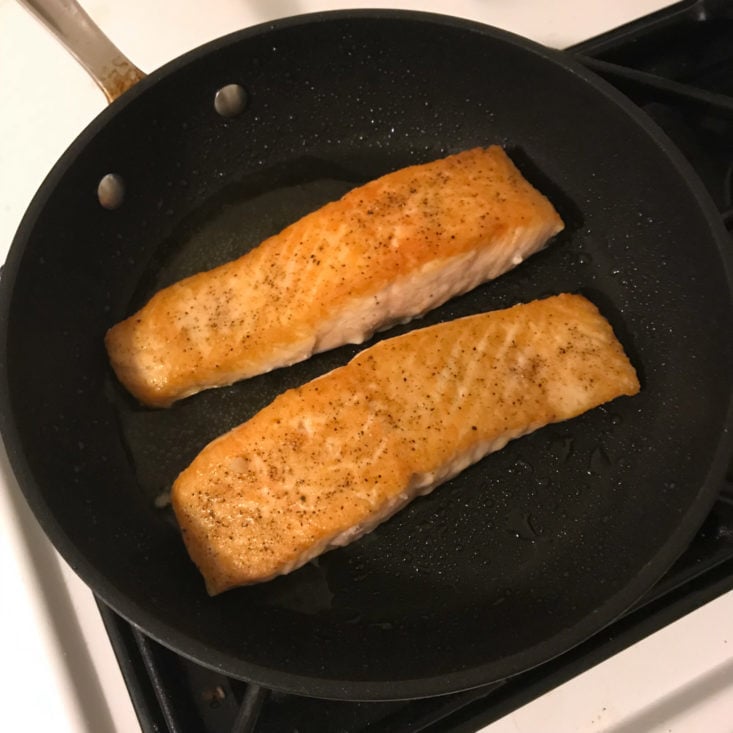 salmon searing in pan, skin side down