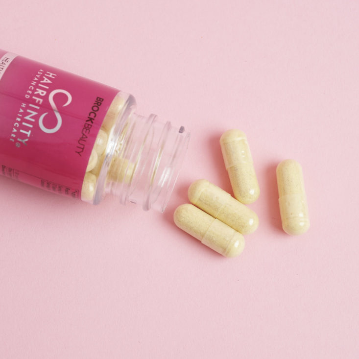 hairfinity healthy hair vitamins pouring out of bottle