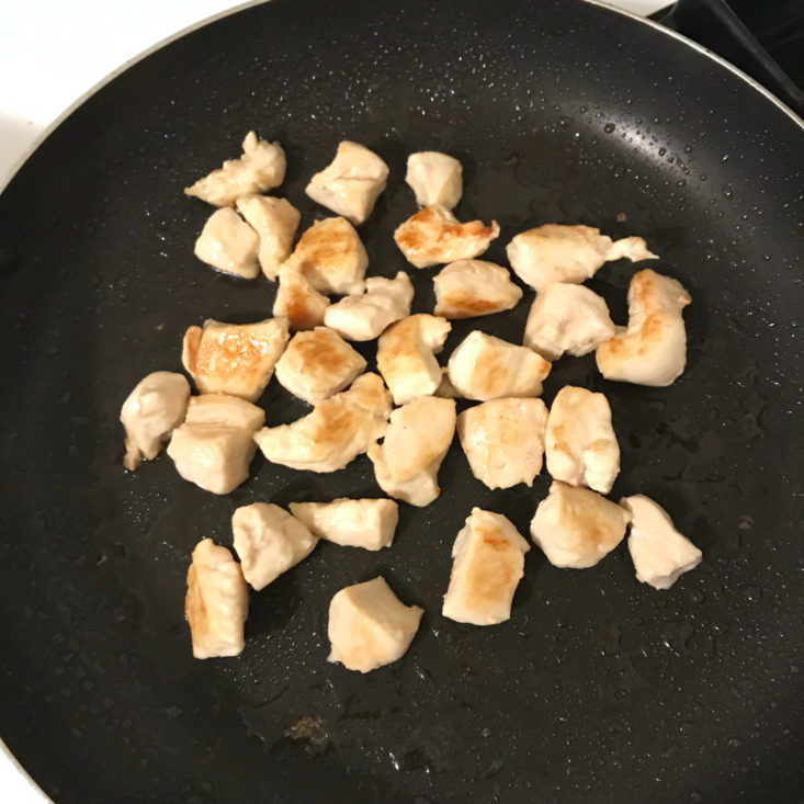diced chicken cooking in pan