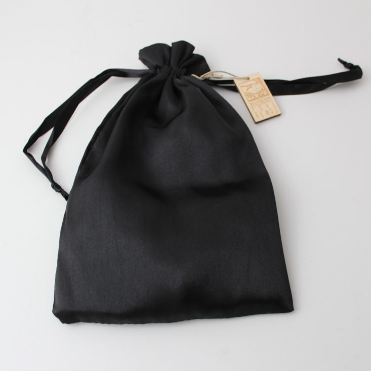 black silk pouch cinched closed