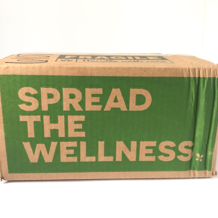 closed Lucky Vitamin box with "Spread The Wellness" written on the side.