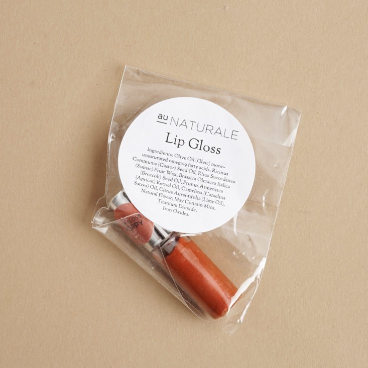 bag with au naturale lip gloss sample in Poppy