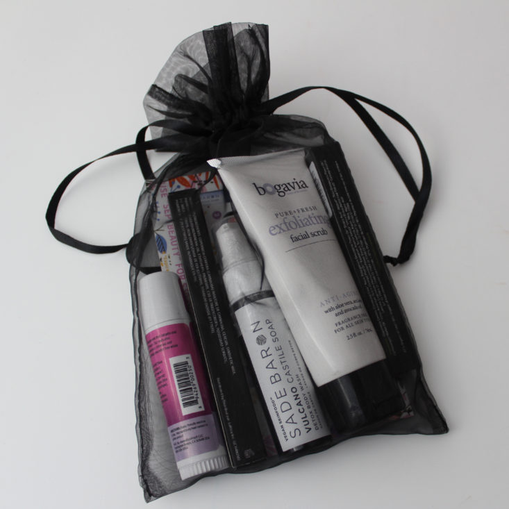 products packaged in a black organza bag tied