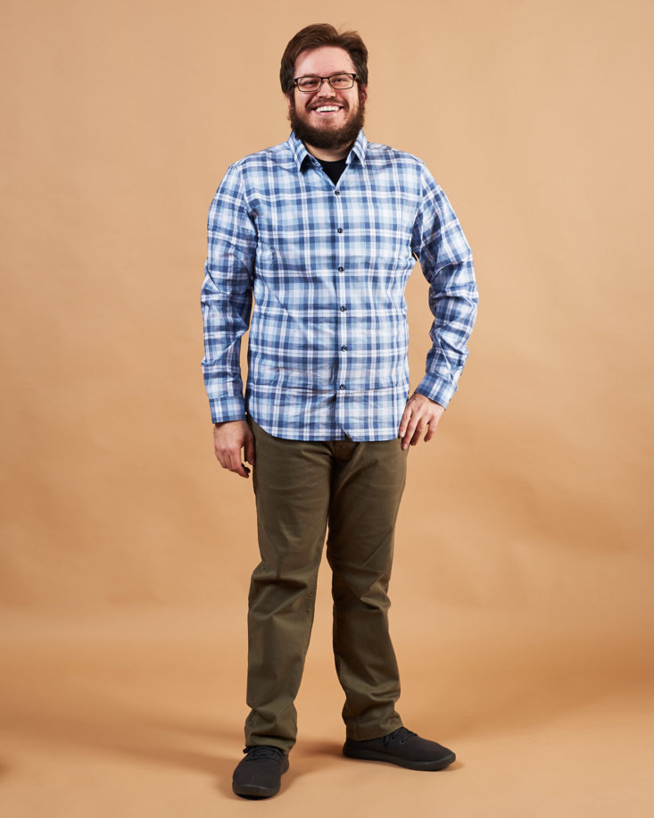 Eric wearing a blue plaid shirt and dark khaki pants from the Bombfell men's clothing subscription.