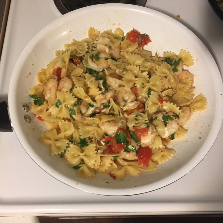 parsley added to the pan with shrimp and pasta