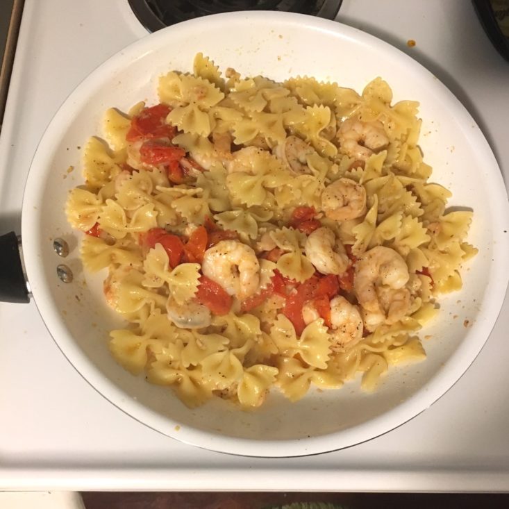 shrimp and pasta added to the pan