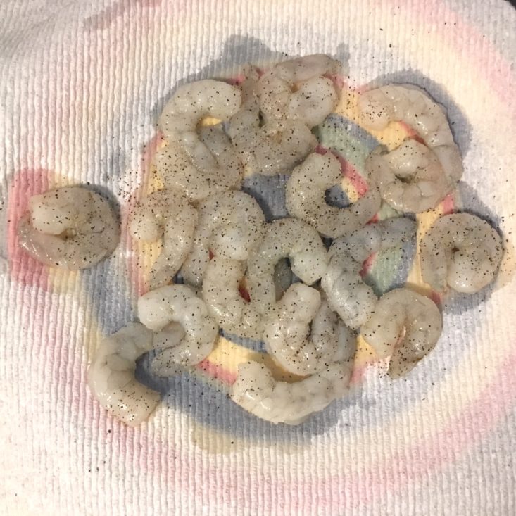  shrimp drying on a paper towel with seasoning