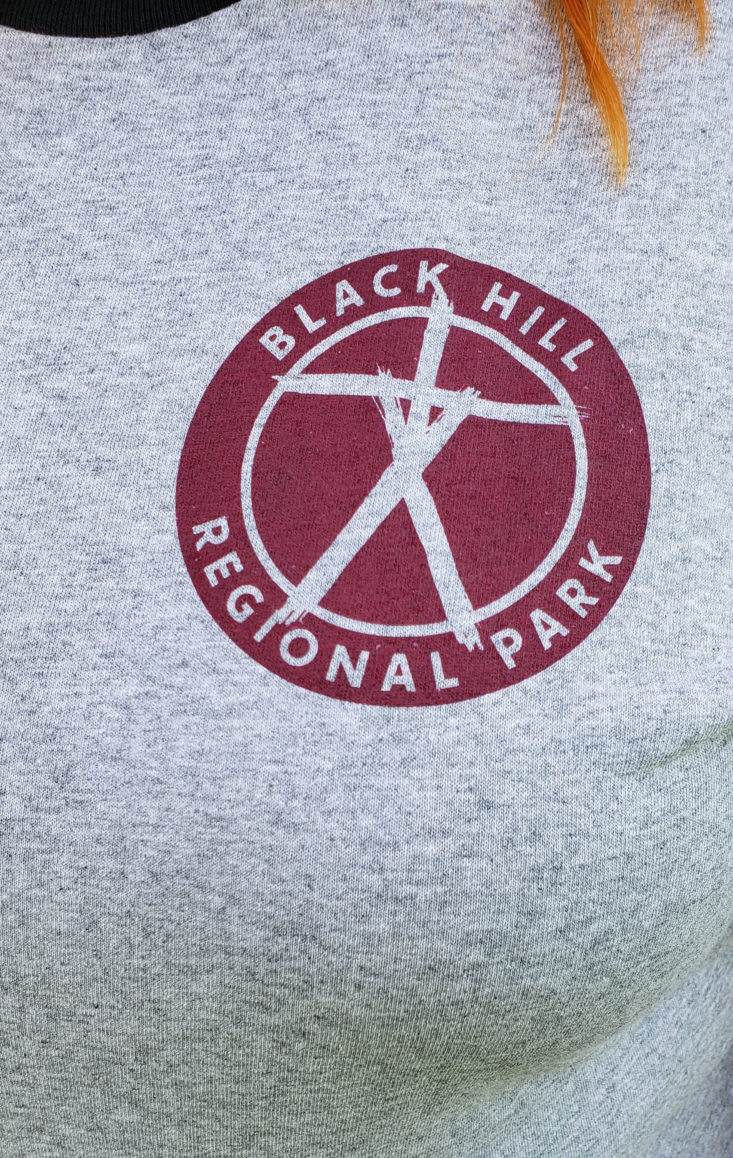 Creepy Crate Spooky Goodies Summer 2019 - Black Hill Regional T- Shirt Wearing Closeup Front